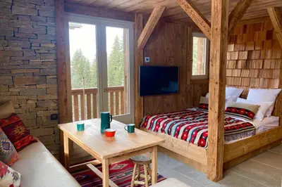 a bedroom with a bed and a table in a room at Apartment NAVAJO by JAPANDI home in Megève