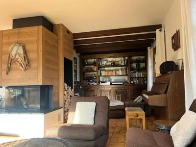 a living room with a couch and chairs and a fireplace at Chalet familial à Megève, vue sur le village in Megève