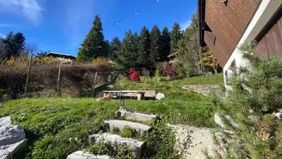 a garden with stone steps and a picnic table at Chalet familial à Megève, vue sur le village in Megève