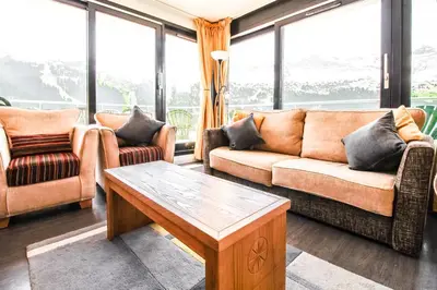 a living room with couches and a coffee table at Penthouse 3-bedroom apartment, mountain views, large terrasse, piste access in Flaine