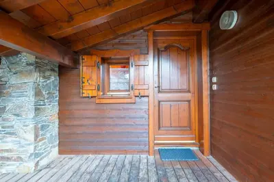 a wooden door in the side of a house at Le Hameau des Neiges in Les Houches