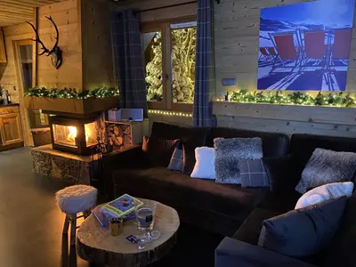 a living room with a couch and a fireplace at Chalet Megeve, idéal familles proche ski et centre village in Megève