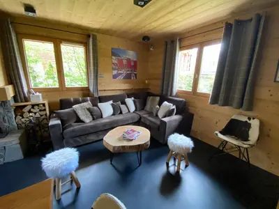 a living room with a couch and a table at Chalet Megeve, idéal familles proche ski et centre village in Megève