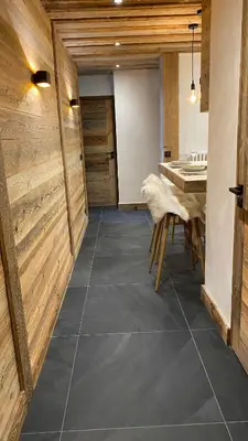 a kitchen with wooden walls and a table and chairs at A place 2 be, Megève centre in Megève