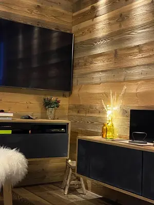a living room with a television and a table with a desk at A place 2 be, Megève centre in Megève
