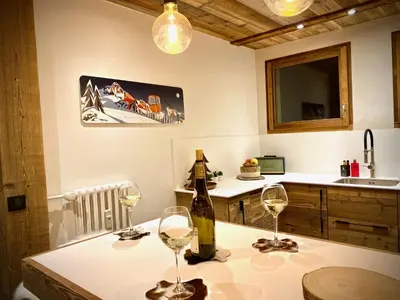 a kitchen with two glasses of wine on a table at A place 2 be, Megève centre in Megève