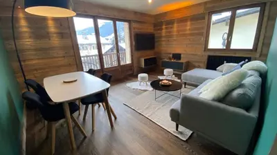 a living room with a couch and a table at A place 2 be, Megève centre in Megève