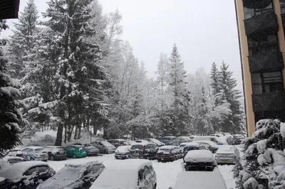 a snow covered parking lot with cars covered in snow at Chamonix / Argentière - Duplex 6p in Chamonix-Mont-Blanc