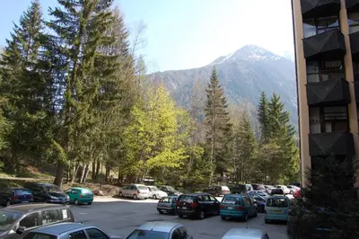 a parking lot with cars parked in front of a mountain at Chamonix / Argentière - Duplex 6p in Chamonix-Mont-Blanc