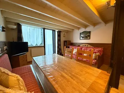 a living room with a table and a dining room at Chamonix / Argentière - Duplex 6p in Chamonix-Mont-Blanc