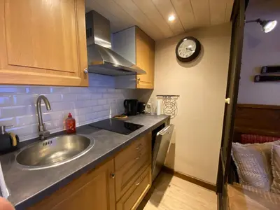 a kitchen with a sink and a clock on the wall at Chamonix / Argentière - Duplex 6p in Chamonix-Mont-Blanc