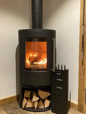 a stove with a fire in a room at CHALET 