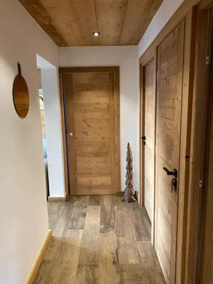 a hallway with a wooden door in a house at CHALET 