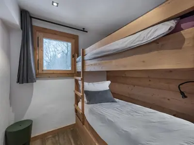 a bedroom with two bunk beds and a window at CHALET 