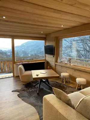 a living room with a couch and a table at CHALET 