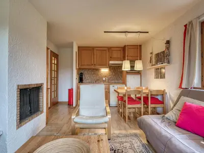 a living room and kitchen with a couch and a table at Appartement 2 pièces avec terrasse, animaux admis, proche pistes - Megève - FR-1-453-225 in Megève
