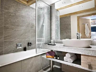 a bathroom with a sink and a tub at MGM Hôtels & Résidences - Résidence Chalets Laska in Les Contamines-Montjoie