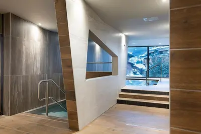 a bathroom with a walk in shower and a window at MGM Hôtels & Résidences - Résidence Chalets Laska in Les Contamines-Montjoie