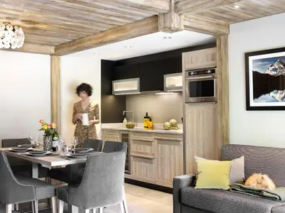 a kitchen and dining room with a table and chairs at MGM Hôtels & Résidences - Résidence Chalets Laska in Les Contamines-Montjoie