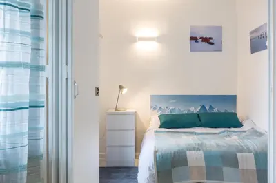 a bedroom with a bed with a green pillow at Apartment Mont du Soleil - Central Chamonix Mont Blanc in Chamonix-Mont-Blanc