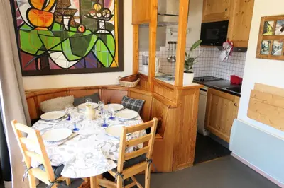 a kitchen with a table with chairs and a painting at Résidence Jaspe - Jaspe 1123 MAE-2444 in Saint-Gervais-les-Bains