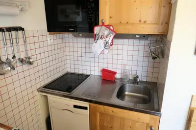 a kitchen with a sink and a tiled wall at Résidence Jaspe - Jaspe 1123 MAE-2444 in Saint-Gervais-les-Bains