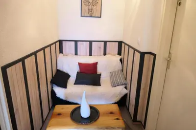 a chair with pillows and a vase on a table at Résidence Jaspe - Jaspe 1123 MAE-2444 in Saint-Gervais-les-Bains
