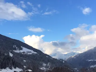 a view of a mountain range with snow and clouds at Bel appartement au décor Montagnard - 80m2 in Les Contamines-Montjoie
