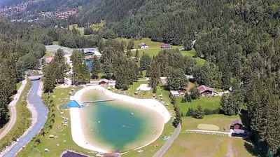 an aerial view of a lake in the middle of a forest at Bel appartement au décor Montagnard - 80m2 in Les Contamines-Montjoie