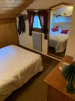 a bedroom with two beds and a mirror at Bel appartement au décor Montagnard - 80m2 in Les Contamines-Montjoie