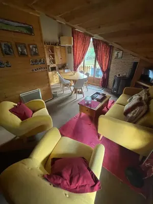 a living room with two couches and a table at Bel appartement au décor Montagnard - 80m2 in Les Contamines-Montjoie