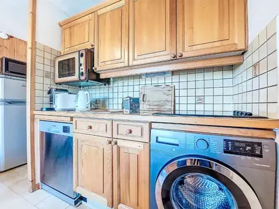 a kitchen with a washing machine and a microwave at Apartment Pointe des aravis B13 by Interhome in Saint-Gervais-les-Bains