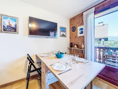 a bedroom with a bed and a shelf on the wall at Apartment Pointe des aravis B13 by Interhome in Saint-Gervais-les-Bains