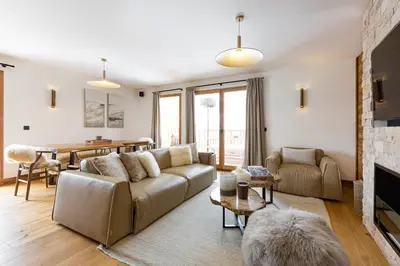 a living room with a couch and a table at Le Refuge des Anges in Megève