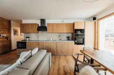 a kitchen with a couch and a table in a room at Le Refuge des Anges in Megève