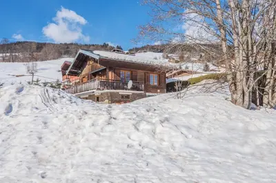 a house in the snow with a pile of snow at Le Chalet des Neiges - Welkeys in Megève