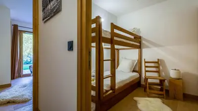 a bedroom with two bunk beds and a doorway at Appartement Green in Chamonix-Mont-Blanc