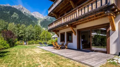 a house with a deck with a view of mountains at Appartement Green in Chamonix-Mont-Blanc