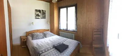 a bedroom with a bed and a window at Le clair logis in Sixt
