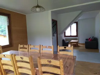 a dining room with a wooden table and chairs at Le clair logis in Sixt