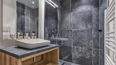 a bathroom with a white sink and a shower at Chalet Hupa in Les Houches