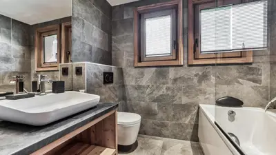 a bathroom with a sink and a tub and a toilet at Chalet Hupa in Les Houches