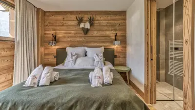 a bedroom with a bed with towels on it at Chalet Hupa in Les Houches