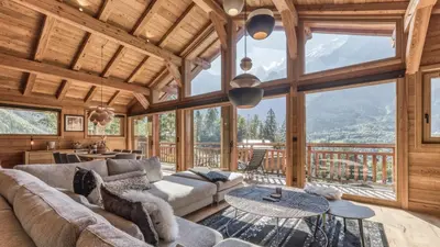 a living room with a couch and a table at Chalet Hupa in Les Houches