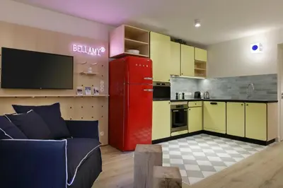 a kitchen with a red refrigerator in a room at Appart'hôtel Bellamy Chamonix in Chamonix-Mont-Blanc
