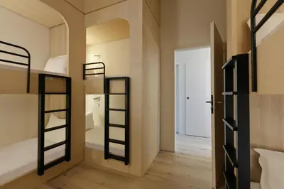 a room with two bunk beds and a hallway at Appart'hôtel Bellamy Chamonix in Chamonix-Mont-Blanc
