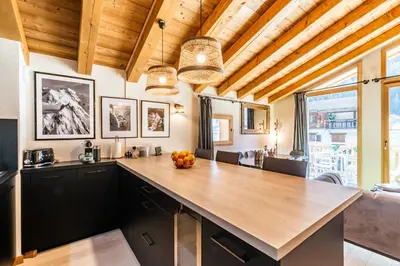 a kitchen with a large wooden counter top in a room at Sapelli apartment Argentière Chamonix - by EMERALD STAY in Chamonix-Mont-Blanc