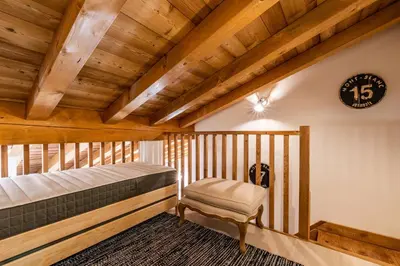 a bedroom with a bed and a clock on the wall at Sapelli apartment Argentière Chamonix - by EMERALD STAY in Chamonix-Mont-Blanc