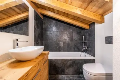 a bathroom with a white sink and a toilet at Sapelli apartment Argentière Chamonix - by EMERALD STAY in Chamonix-Mont-Blanc