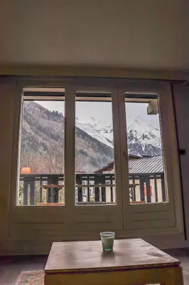 a room with a window with a view of a mountain at Appartement Lyret centre Chamonix, Vue d'exception in Chamonix-Mont-Blanc